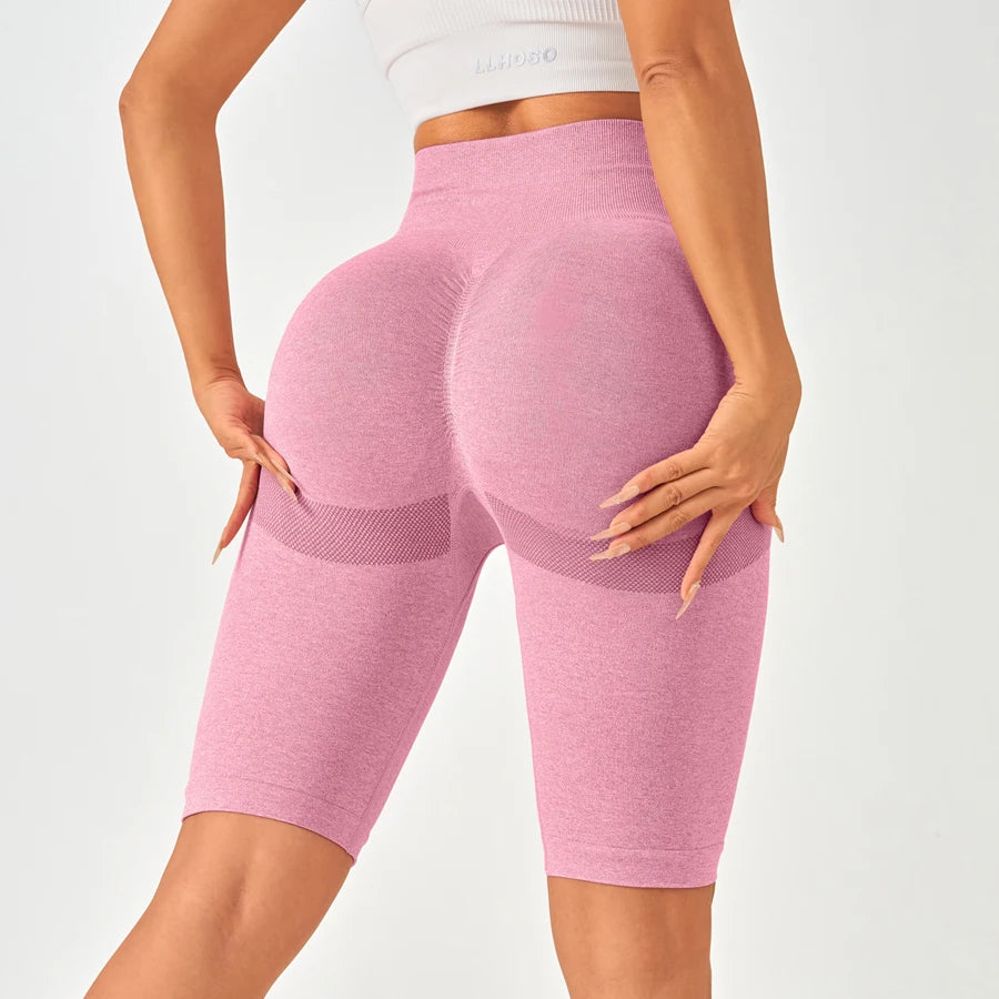 Light pink high-waisted seamless leggings with mesh-like side patterns, designed for a flattering butt-lifting effect.