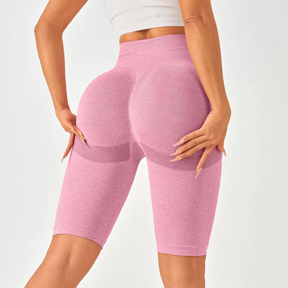Light pink high-waisted seamless leggings with mesh-like side patterns, designed for a flattering butt-lifting effect.
