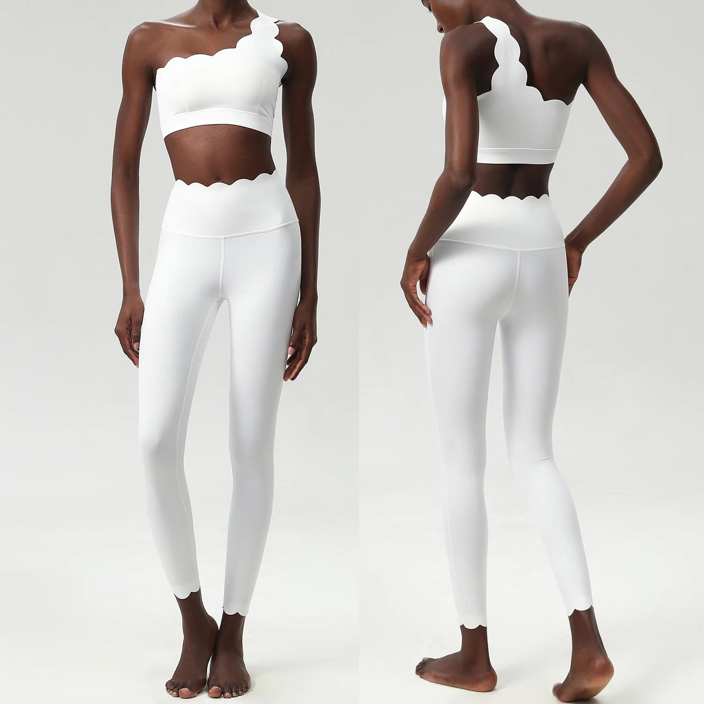 Stylish two-piece fitness yoga set featuring a scalloped crop top and form-fitting leggings in a chic white design.