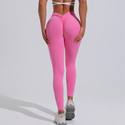 Vibrant pink women's yoga pants featuring a high V-waist and ruched detail for an elegant, flattering fit.