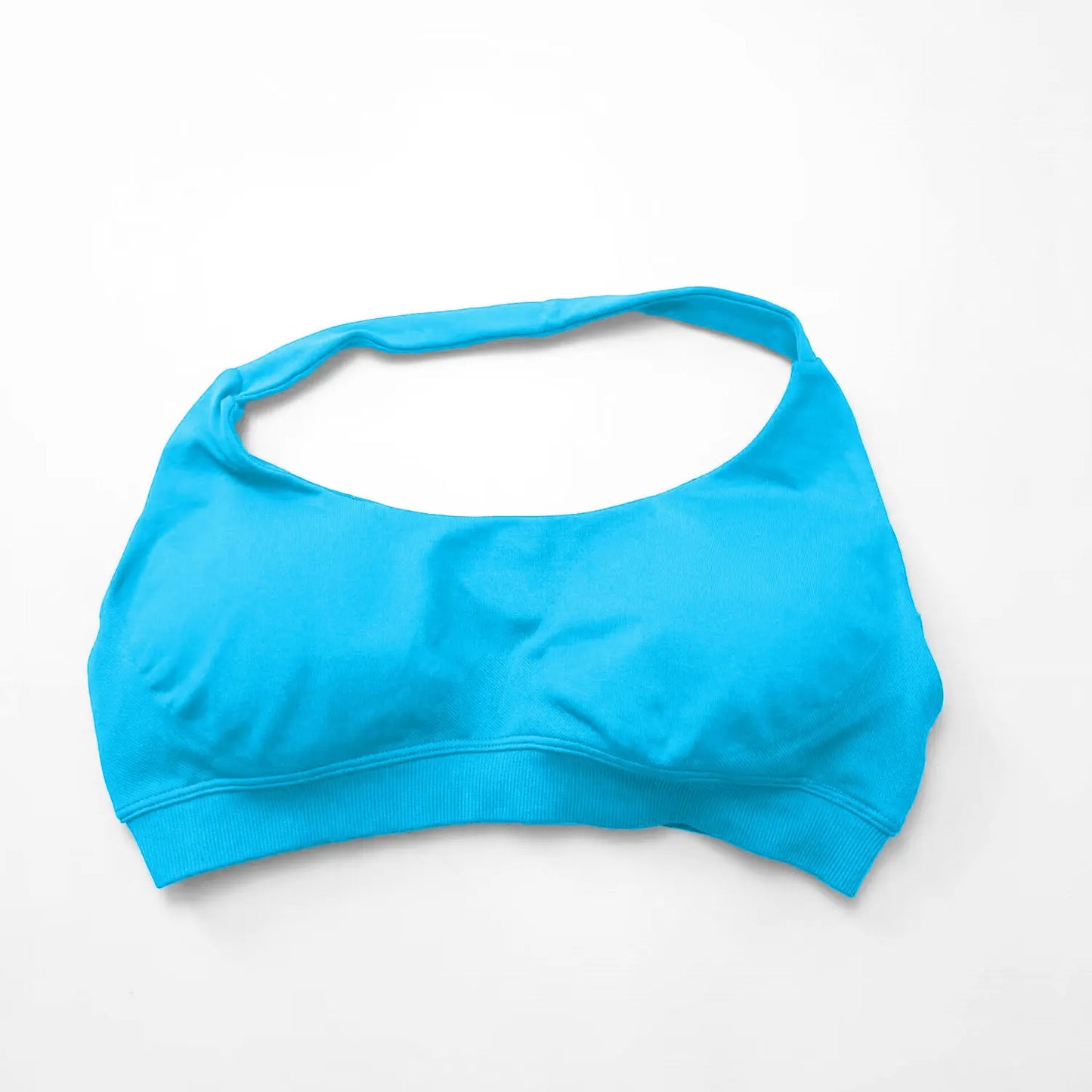 Bright blue seamless halter sports bra featuring an open-back design and thin straps for elegant support during workouts.
