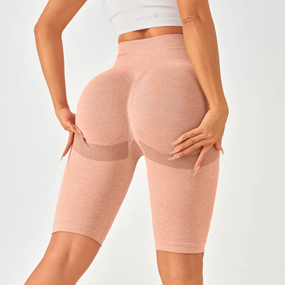 High-waisted seamless leggings in light peach with textured pattern and mesh detailing, perfect for a flattering fit.