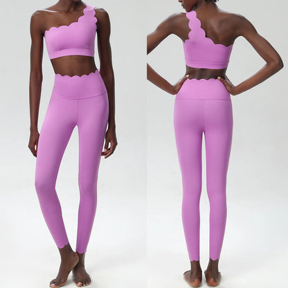 Two-piece pink fitness yoga set featuring scalloped edges and form-fitting leggings, showcasing elegance and style.