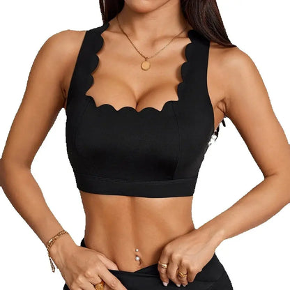 Black Anfilia sports bra featuring a square neck, scalloped trim, and elegant cross straps, perfect for an active lifestyle.
