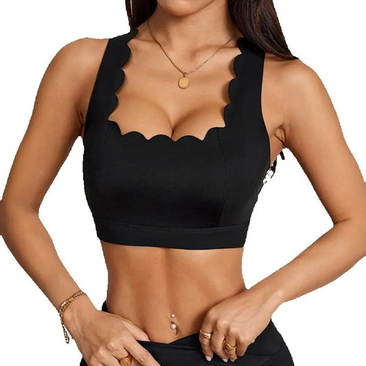 Black Anfilia sports bra featuring a square neck, scalloped trim, and elegant cross straps, perfect for an active lifestyle.