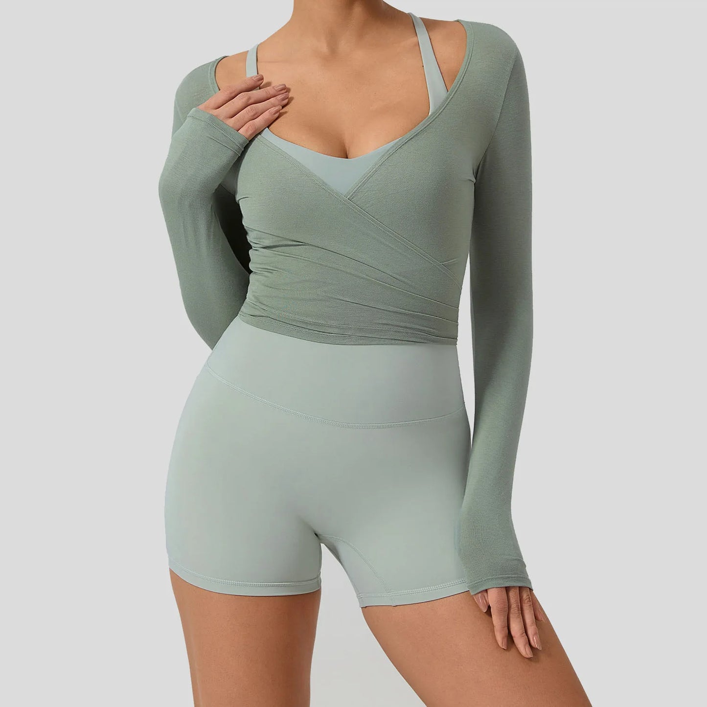 Light green long sleeve yoga shirt featuring a chic wrap design and flattering V-neckline, perfect for stylish workouts.