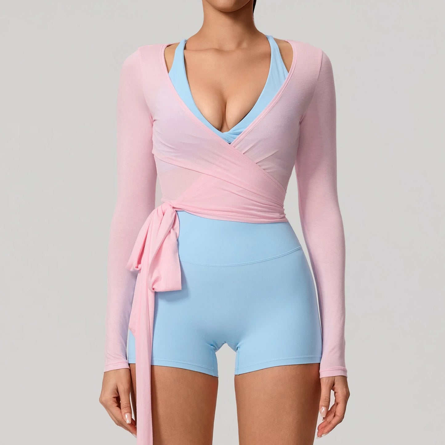 Long sleeve Hearuisavy yoga shirt in pink and light blue, featuring a chic wrap design and flattering V-neckline.