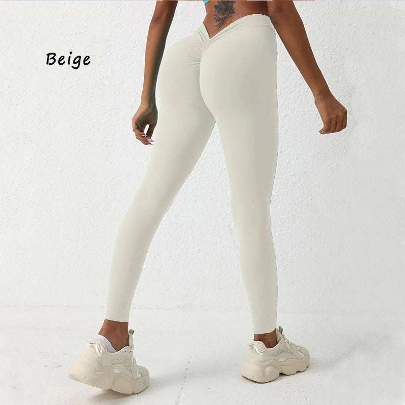 Form-fitting light beige yoga pants with a high V-waist design, perfect for enhancing your silhouette during workouts.