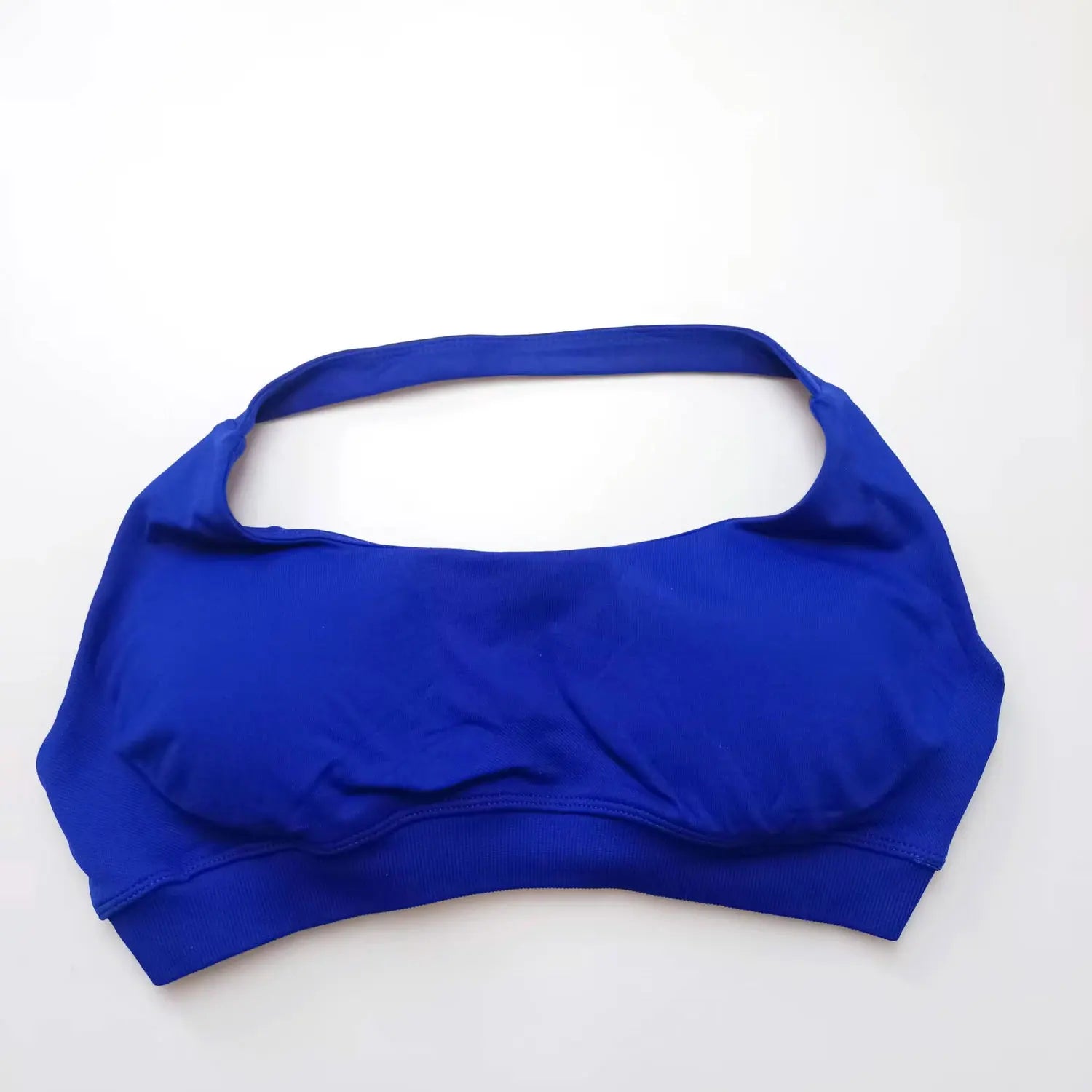 Blue seamless halter sports bra featuring an open-back design and wide bottom band for elegant support during workouts.