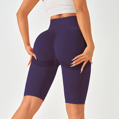 Deep purple high-waisted seamless leggings showcasing a textured pattern and elegant fit around the waist and thighs.