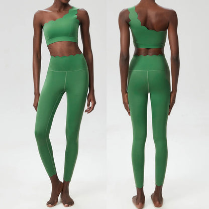 Stylish two-piece fitness set featuring a scalloped cropped top and full-length high-waisted leggings in solid green.