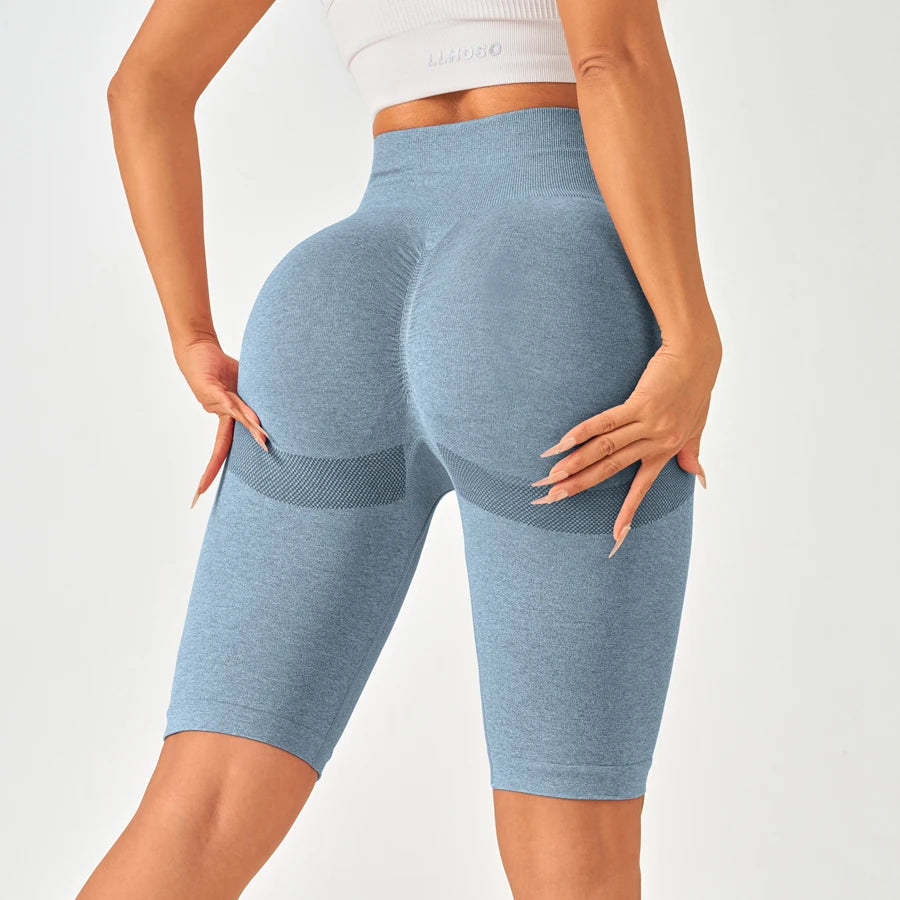 High-waisted seamless leggings in light blue with mesh panels, showcasing a flattering fit and elegant design.