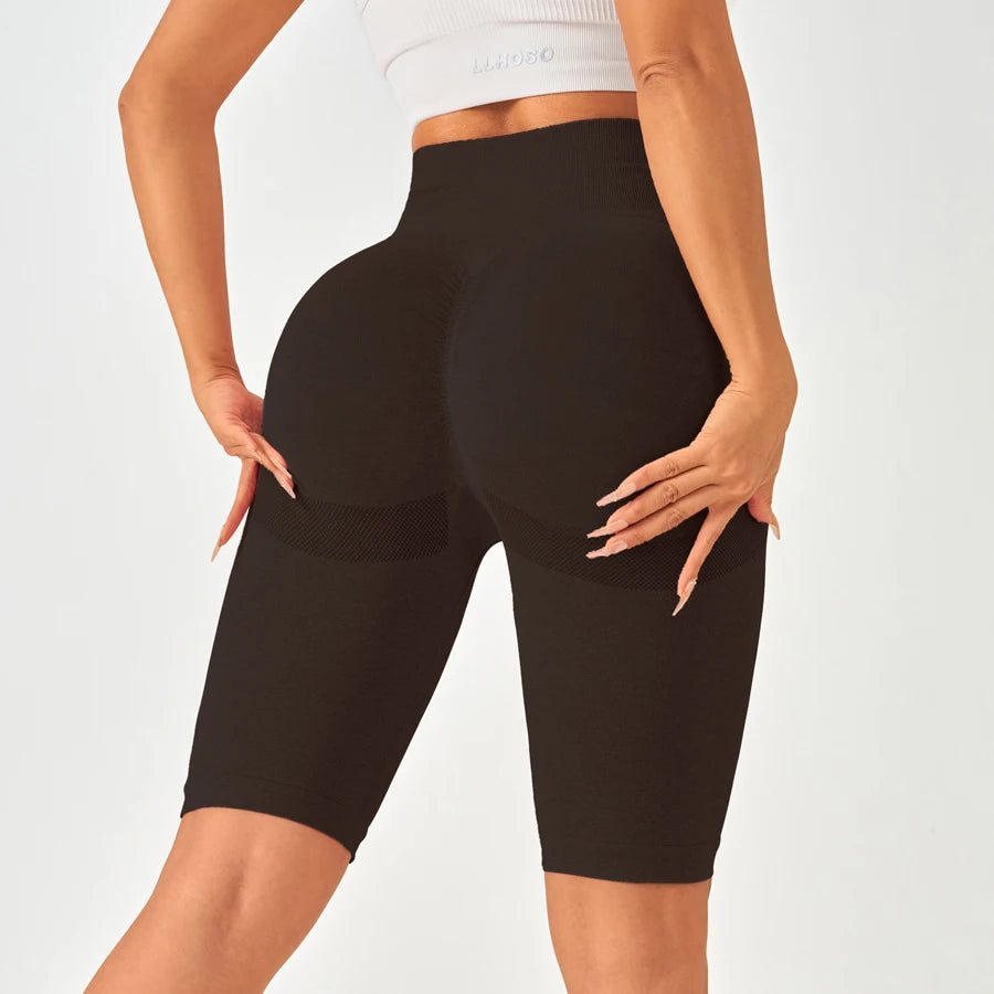 High-waisted black seamless leggings with mesh side panels and a flattering butt-lifting design.