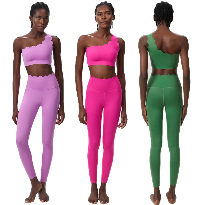 Two-piece fitness yoga set featuring a scalloped crop top and form-fitting leggings, showcased in pink and green.
