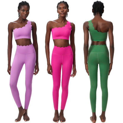 Two-piece fitness yoga set featuring a scalloped crop top and form-fitting leggings, showcased in pink and green.