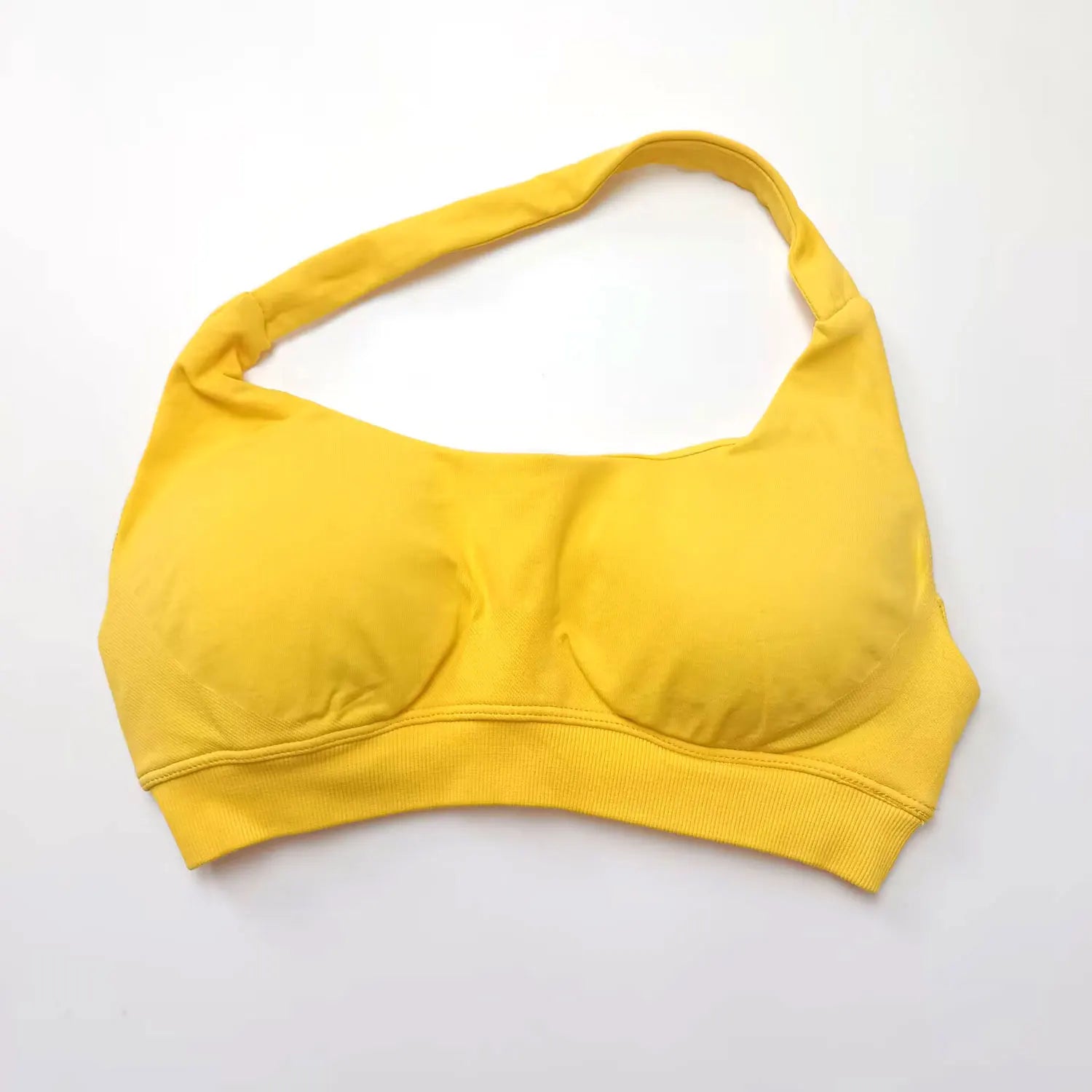 Yellow seamless halter sports bra featuring high support, push-up design, and an elegant open back.